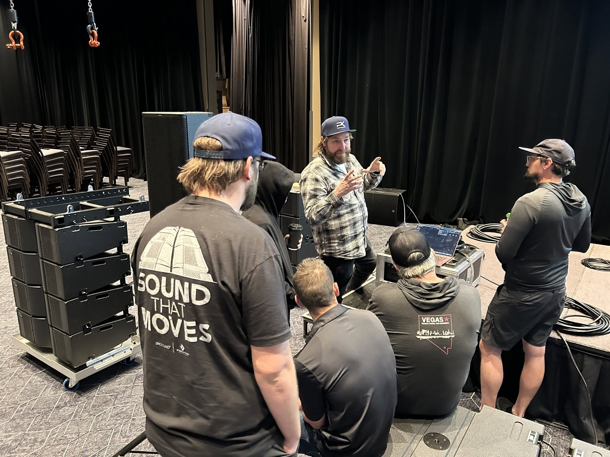 PK Sound engineer teaching a small group around a T8 module stack